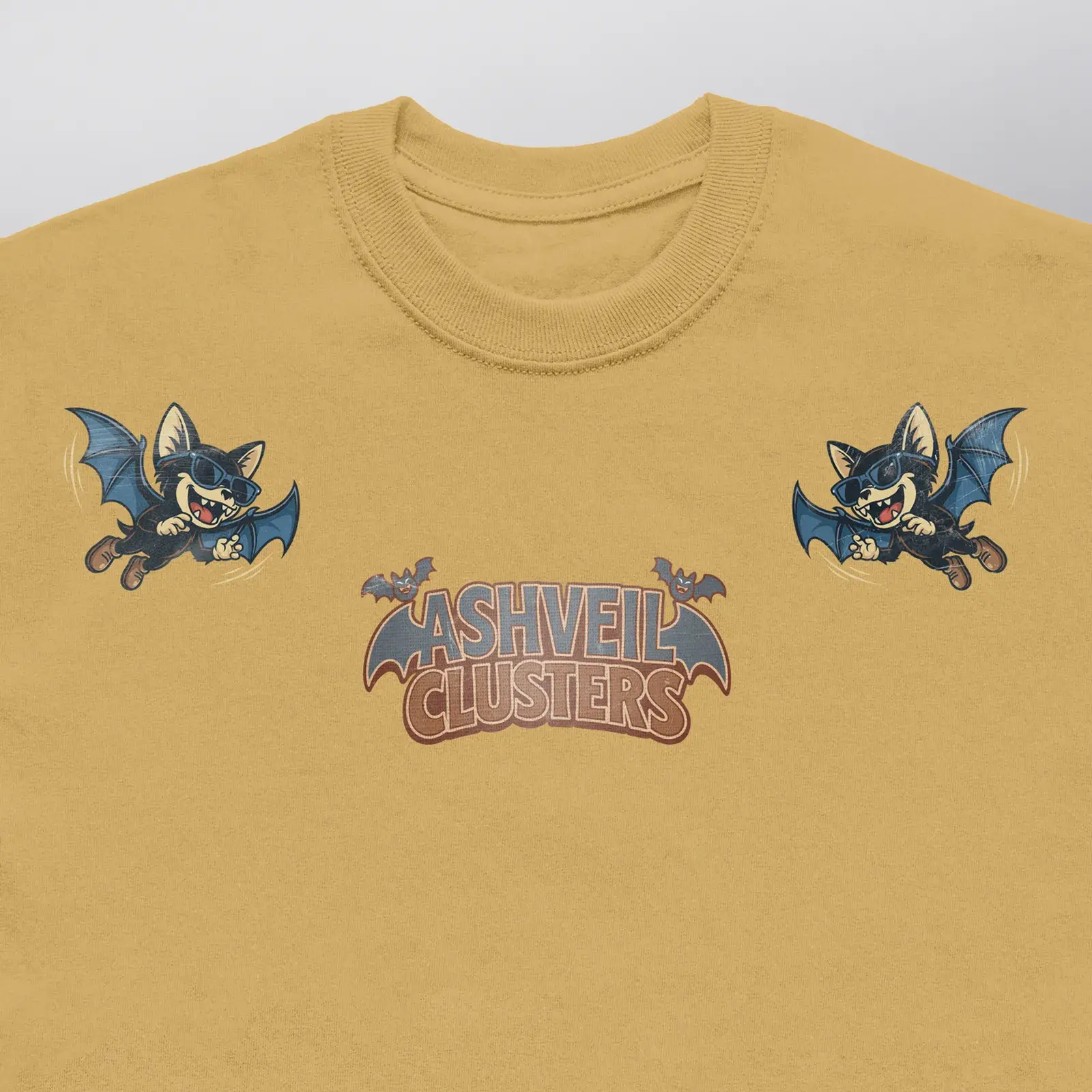 Ashveil Clusters Caramel Tee (Exclusive 1 of 1), close-up of the two FogFang bats in sunglasses and the chest logo