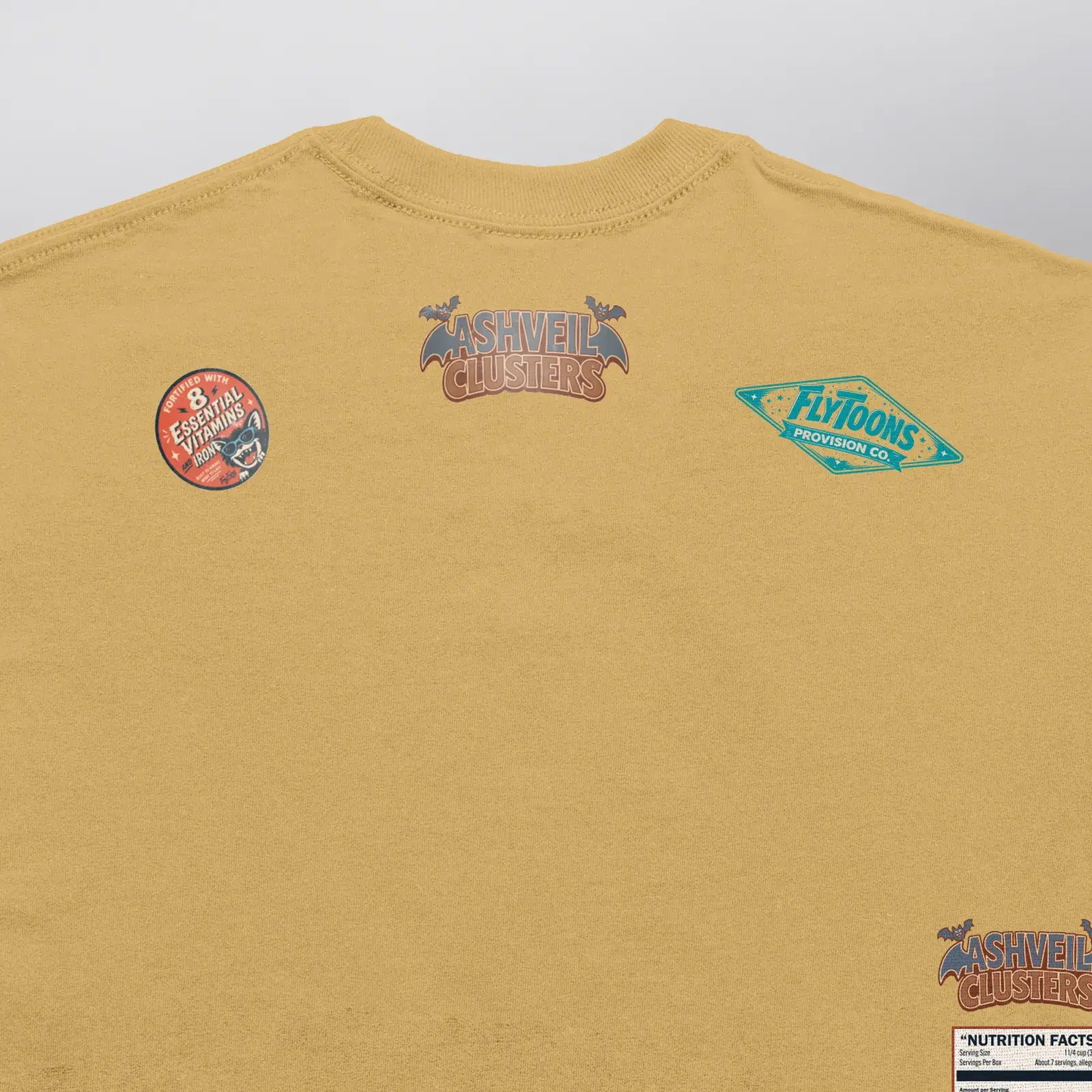 Ashveil Clusters Caramel Tee (Exclusive 1 of 1), close-up of the upper back: logo, vitamin seal and FlyToons Provision Co. badge