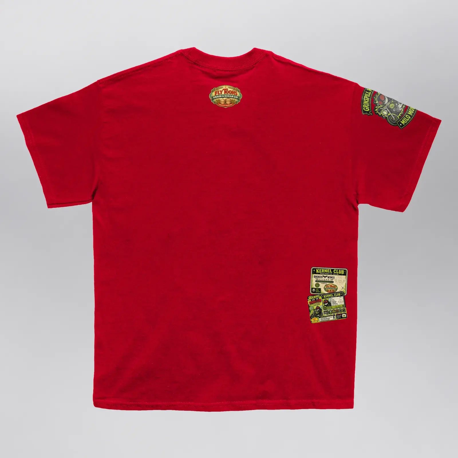 Grinspill Kernels Red Kernel Club Tee (Exclusive 1 of 1), back: a Fly Toons seal under the collar and a Kernel Club card at the hem